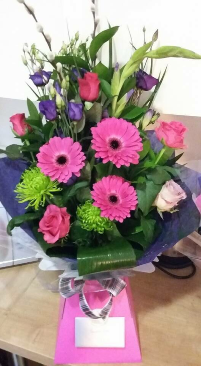 Front Facing Wrap - Lovely mix of cerise pink and purple flowers in one of our DVF front facing wraps. Comes in presentation box with food and water for longer lasting stems. Includes local delivery. Exact flowers may vary depending on availability.