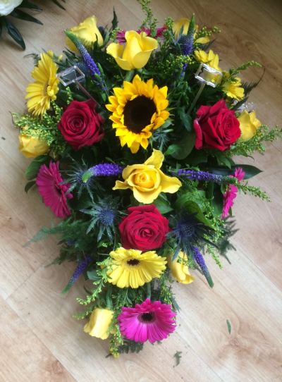 Vibrant single end spray - A lovely vibrant tribute including yellows, reds, cerise and purple. 
