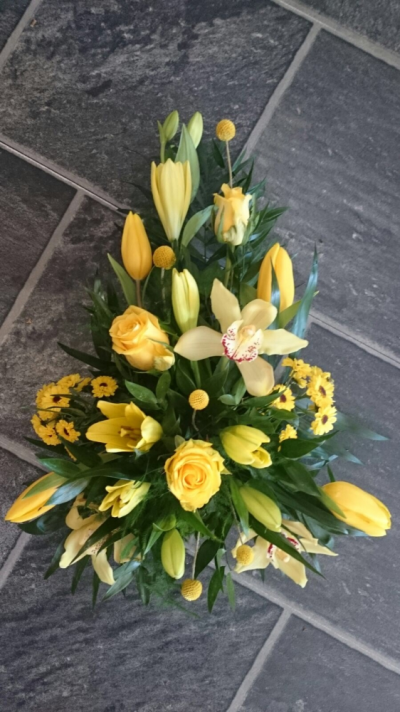 Yellow Single Ended Spray - A single ended spray using a mix of seasonal yellow flowers. In this picture we have orchids, roses and lilies along with other flowers. Flowers may vary depending on availability. Including local delivery.