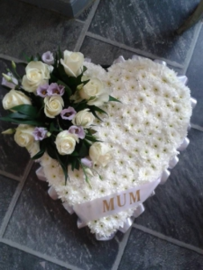 White Heart Wreath - A beautiful Heart wreath, based with white flowers and finished off with ribbon and a spray of your choice. (Please specify colours)